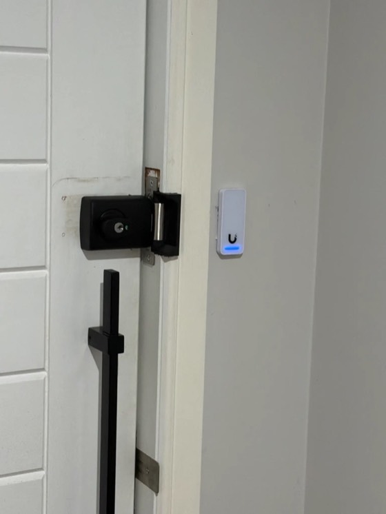 UniFi Access reader installed beside a door lock